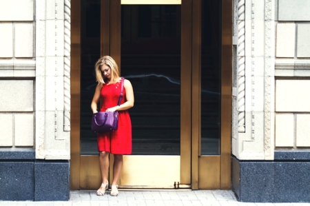 Woman In Red Dress Looking Through Her Purple Purse In Chicago