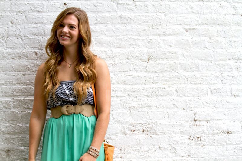 Long-hair-white-brick-wall-teal-happy-smil