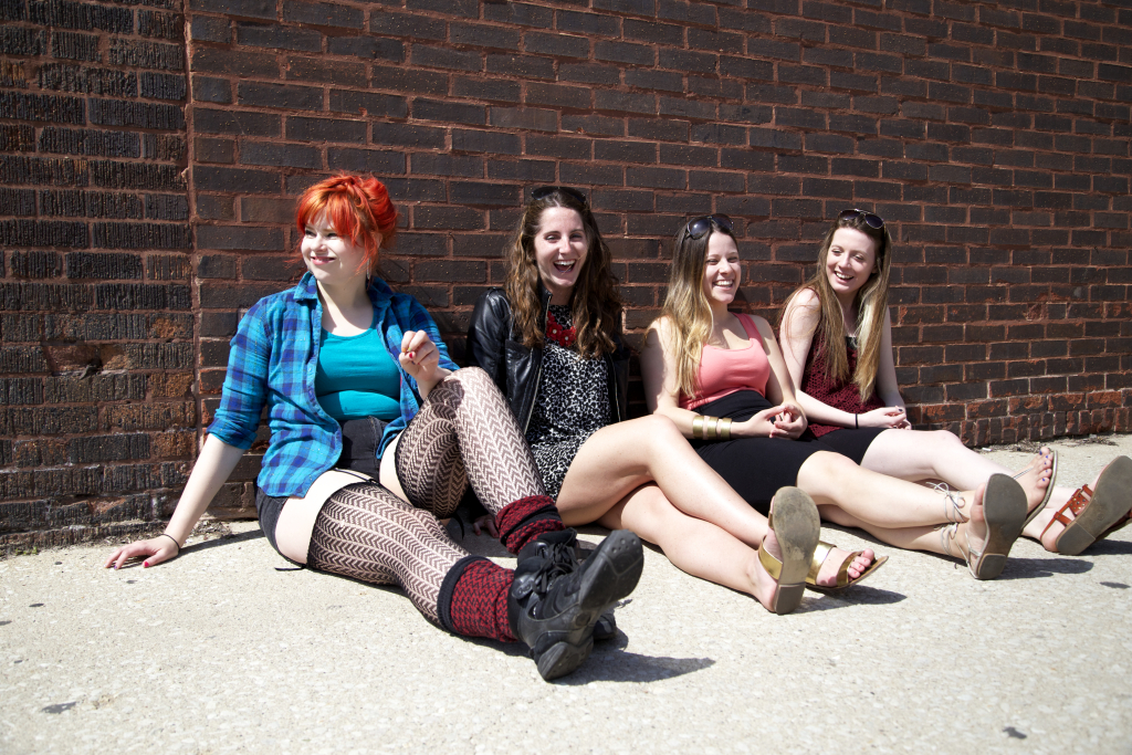 Women-sitting-brick-wall-laughing