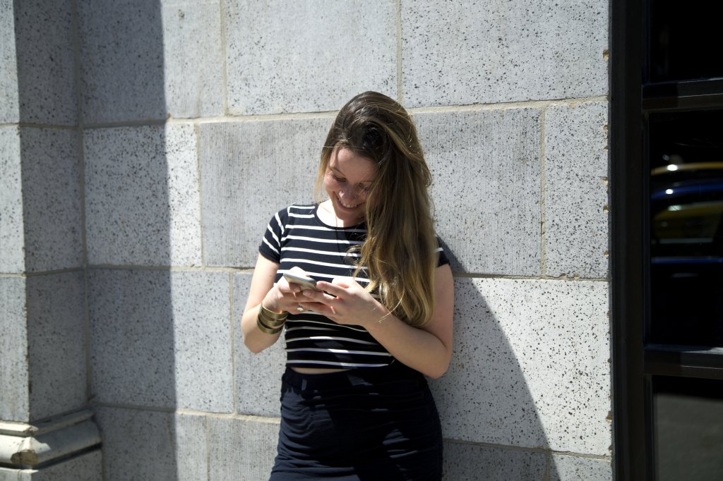 Gracie-Smiling-Using-Phone