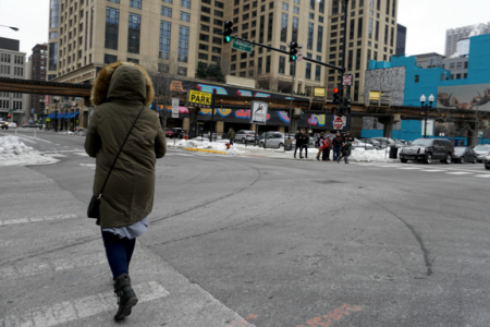 woman-walks-down-street-chicago-south-loop-winter